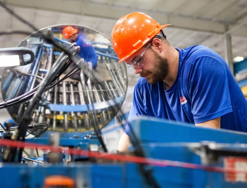 Mining worker in safety gear operating machinery